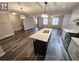 A spacious kitchen with wooden flooring and white appliances.