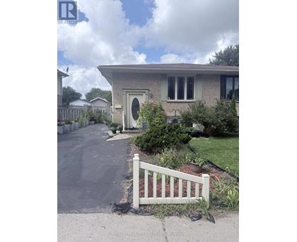 A house with a white fence in front of it.