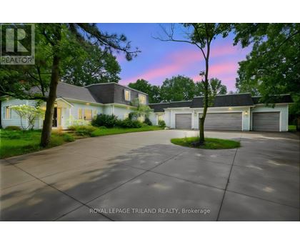 A house with a driveway in front of it at dusk.
