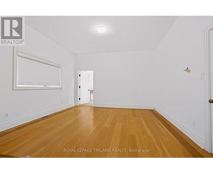 A room with wooden floors and white walls.