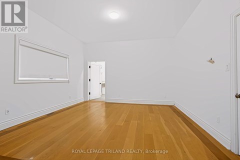 A room with wooden floors and white walls.