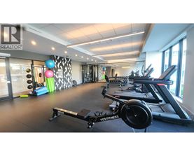 A gym with a variety of equipment including treadmills, exercise bikes, and weights.