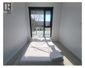 A bedroom with a bed and a window.