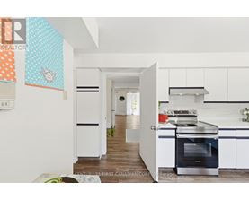 A kitchen with a stove top oven and a refrigerator.