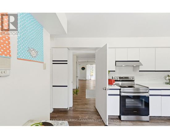 A kitchen with a stove top oven and a refrigerator.