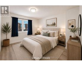 A bedroom with a large bed and a window with blue curtains.