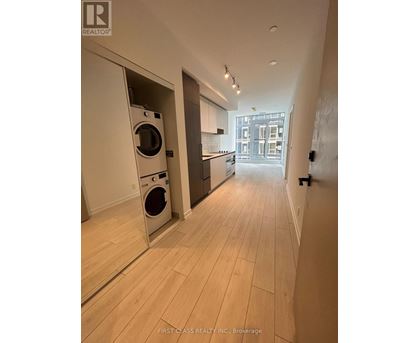 A laundry room with a washer and dryer built into the cabinetry.