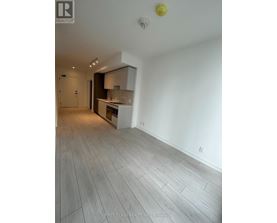 A spacious room with a grey floor and white walls.