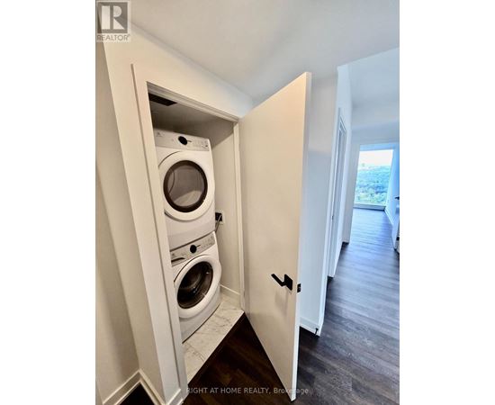 A washer and dryer are built into a wall in a home.