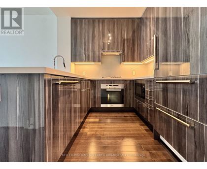 A modern kitchen with wood grain cabinets and a central island.