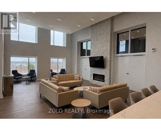 A living room with a stone wall and a fireplace.