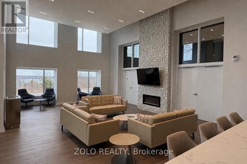 A living room with a stone wall and a fireplace.