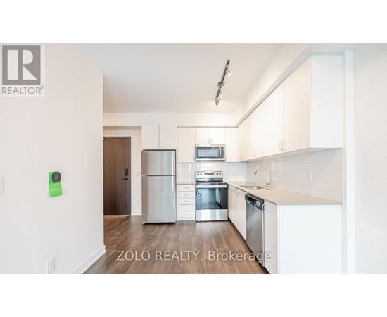 A kitchen with white cabinets and stainless steel appliances.