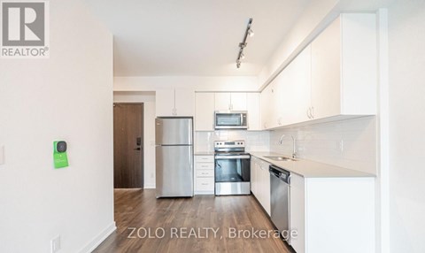 A kitchen with white cabinets and stainless steel appliances.