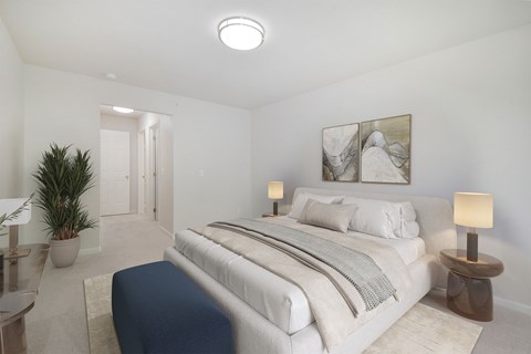 A bedroom with a large bed and a painting on the wall.