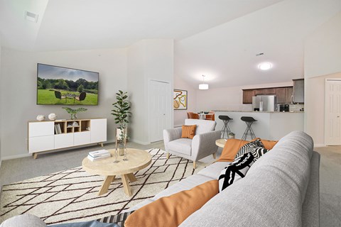A living room with a grey couch and a wooden coffee table.
