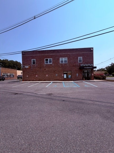 A brick building with the word "Invictus" on it.