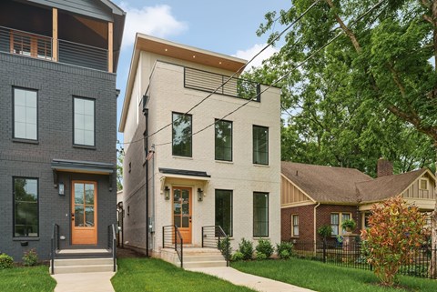 A row of houses with different designs and colors.