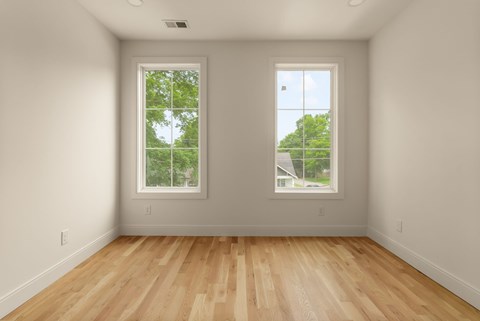 Two windows with trees visible outside.