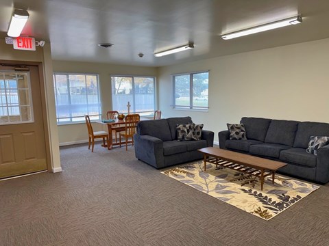 A living room with grey sofas and a wooden coffee table.