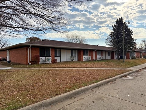 A building with a brown roof and white doors.