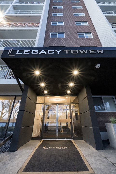 The entrance to the Legacy Tower is shown with a black mat on the ground.