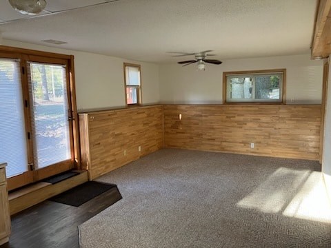 A room with wooden walls and a carpeted floor.