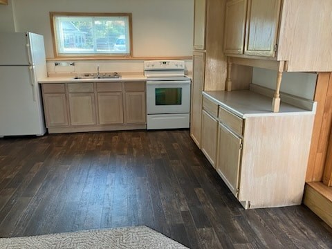 A kitchen with wooden floors and white appliances.
