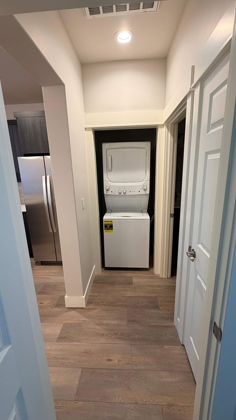 A kitchen with a white fridge and a white dishwasher.