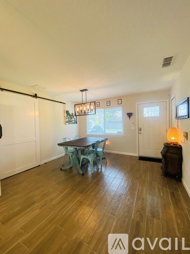 A room with a table and chairs in it.