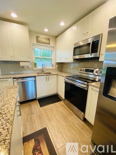 A kitchen with white cabinets and stainless steel appliances.