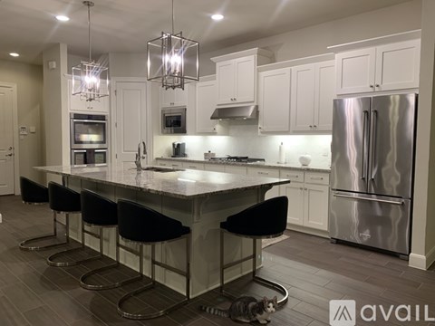 A kitchen with a large island and stainless steel appliances.