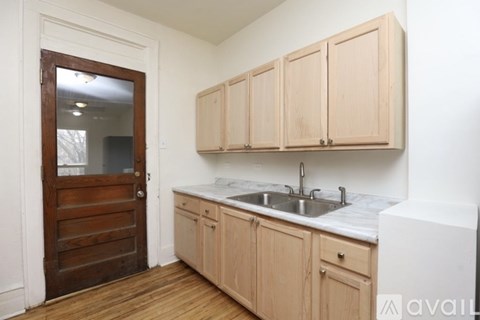 A kitchen with wooden cabinets and a white countertop.