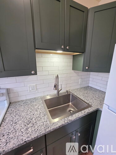 A kitchen with a sink and cabinets.