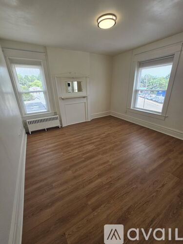 A room with wooden floors and white walls.