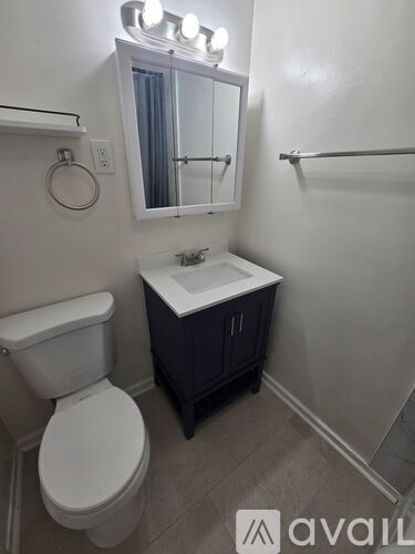 A white toilet sits next to a sink in a bathroom.