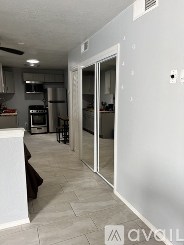 A kitchen with a white counter and a white fridge.