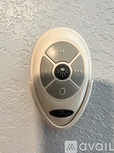 A wall-mounted thermostat with a white background.