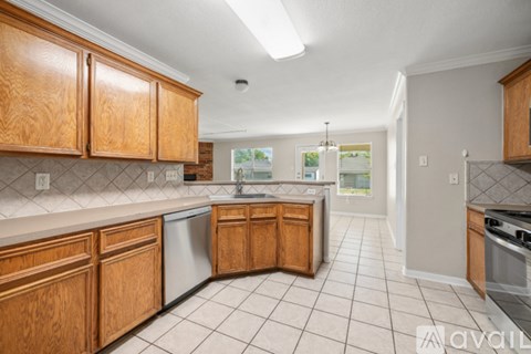A kitchen with wooden cabinets and a dishwasher.