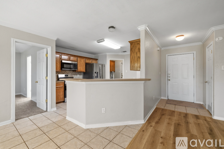 A kitchen with white cabinets and a white island with a countertop.