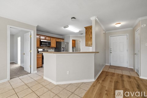 A kitchen with white cabinets and a white island with a countertop.