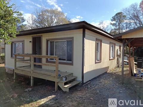 A small house with a porch is available for rent.