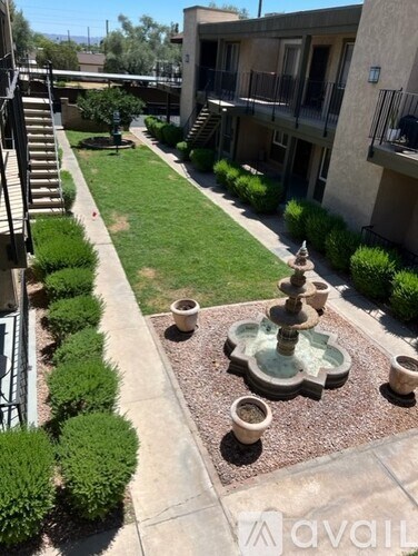 A courtyard with a fountain and apartment buildings.