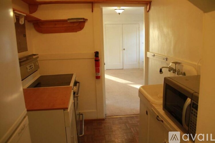 A kitchen with a microwave on the counter.