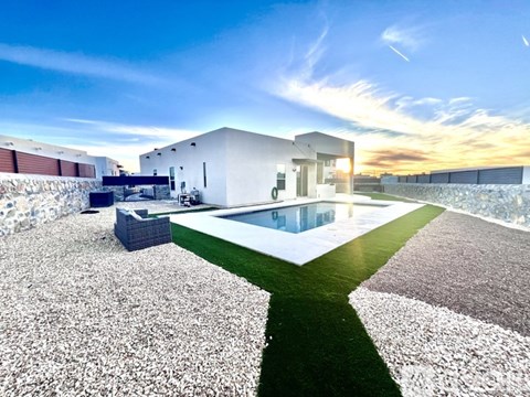 A modern house with a pool in the backyard.