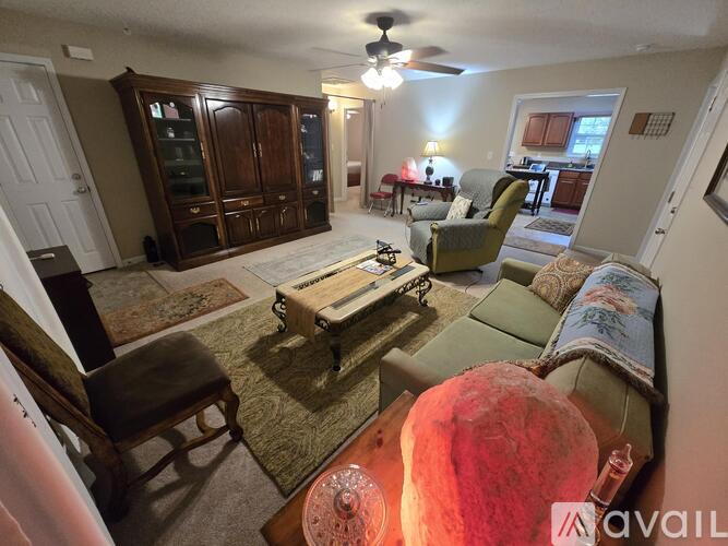 A living room with a couch, chair, and a coffee table.