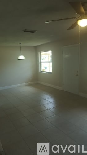 A room with a ceiling fan and a window.