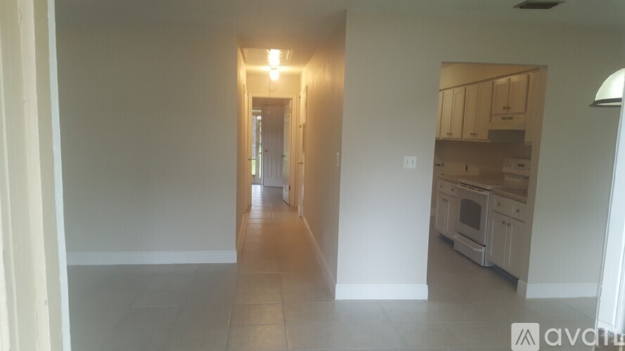 A long hallway with a kitchen at the end.