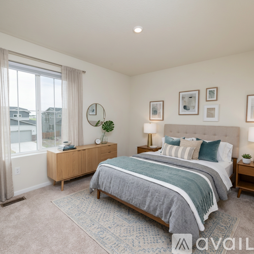 A bedroom with a large bed and a wooden dresser.
