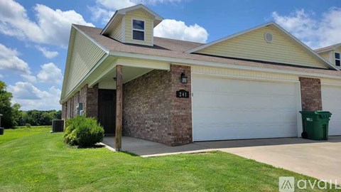 A house with a garage and a driveway.